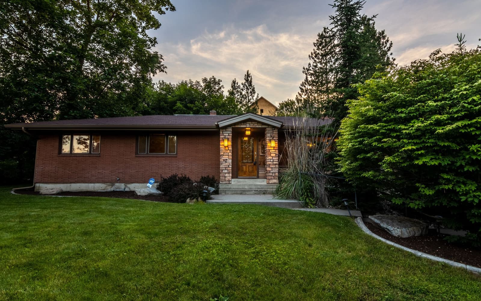 A brick house among trees at dusk